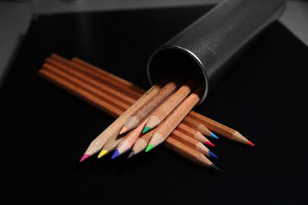Colour pencils sitting in their tin